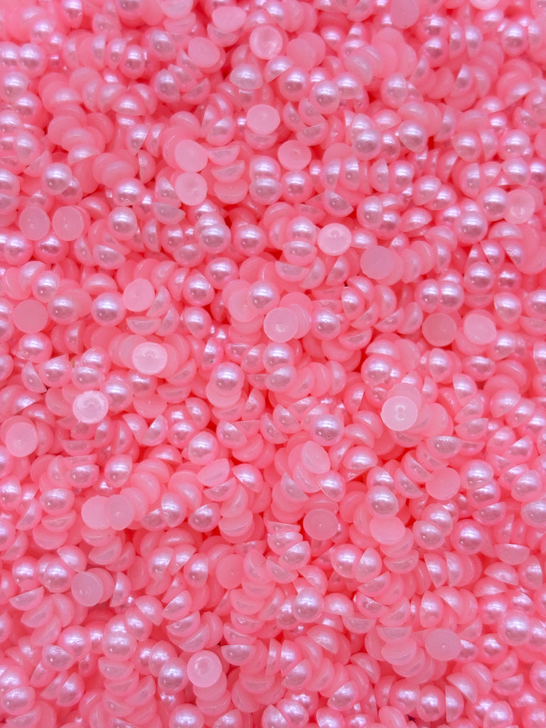 a close up of a bunch of pink pearls