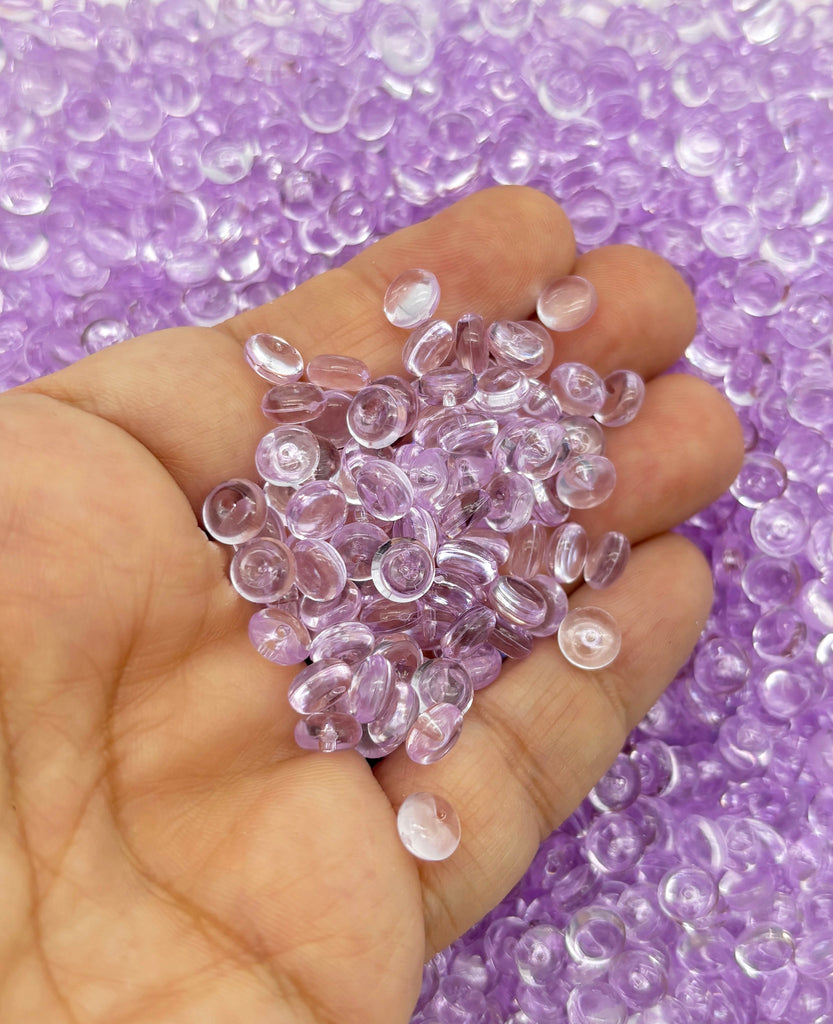 a hand holding a bunch of pink beads