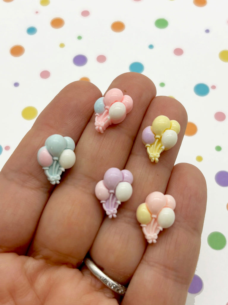 a person is holding a bunch of tiny toys in their hand