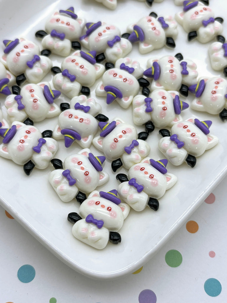 a white plate topped with lots of purple and white teddy bears