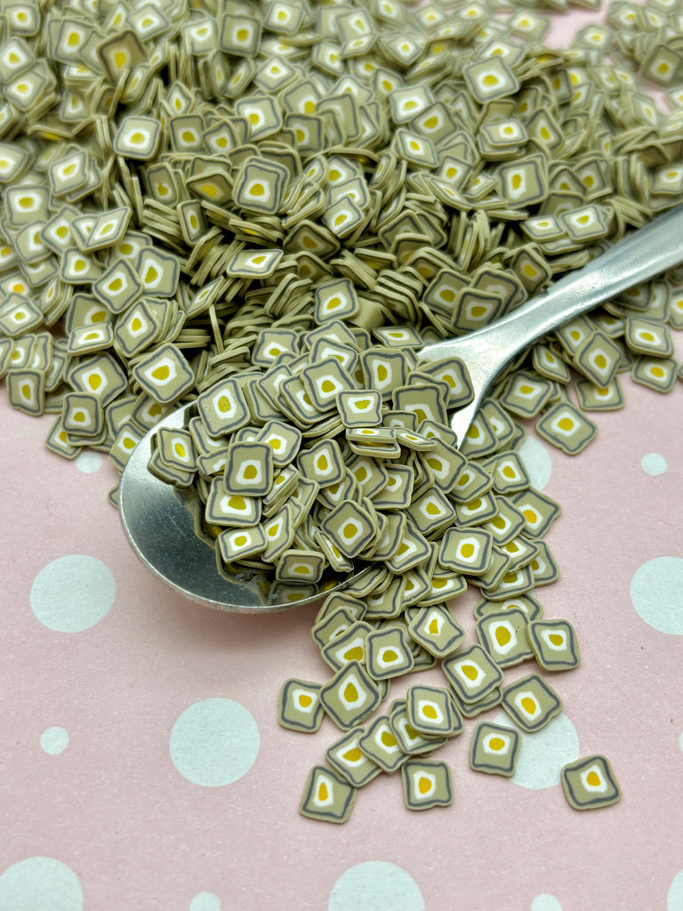 a spoon full of money sitting on top of a table