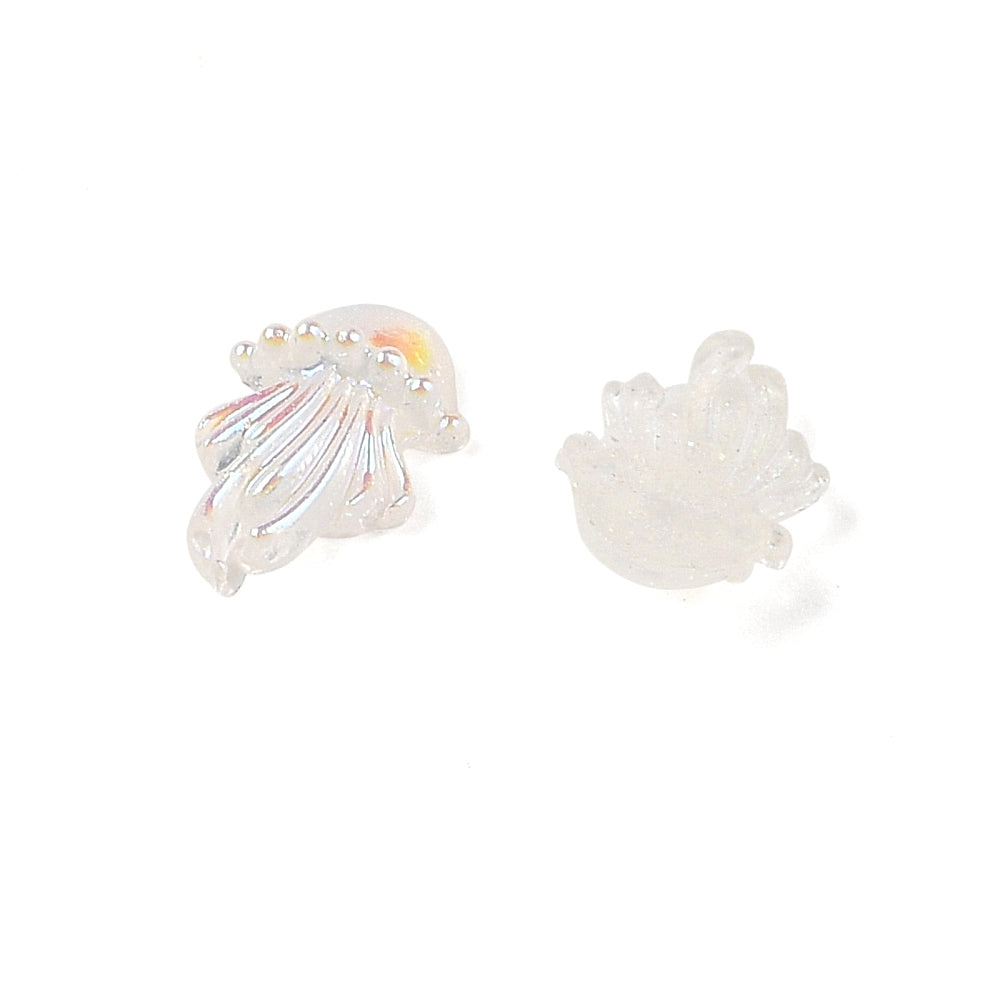 a pair of earrings sitting on top of a white surface