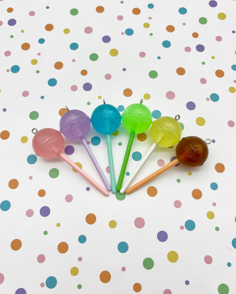 a group of four colorful lollipops sitting on top of a table