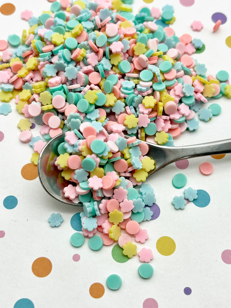 a spoon full of sprinkles on a table