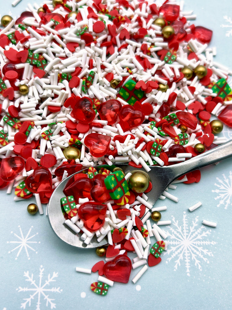 a spoon full of red and white sprinkles