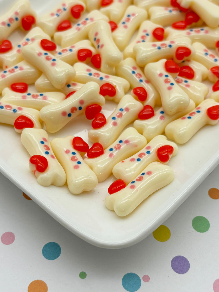 a white plate topped with red, white and blue dog bones