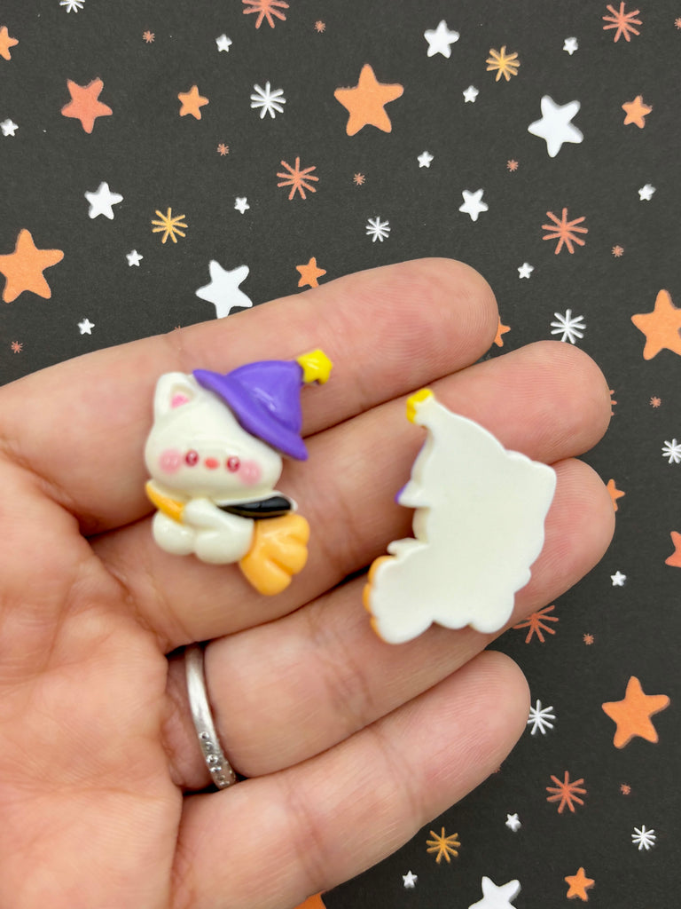 a hand holding a small toy with a small gnome on it