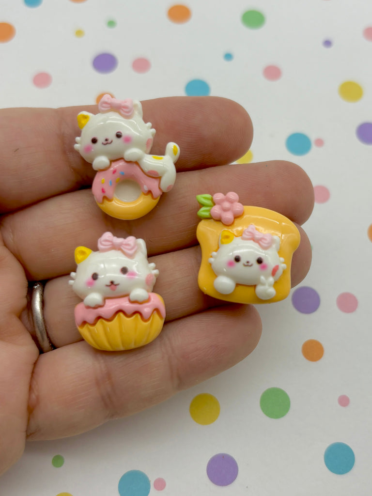 a person is holding three hello kitty rings