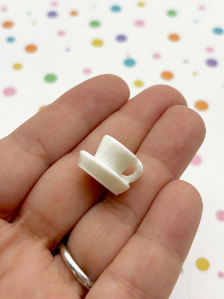 a hand holding a small white object in it's palm