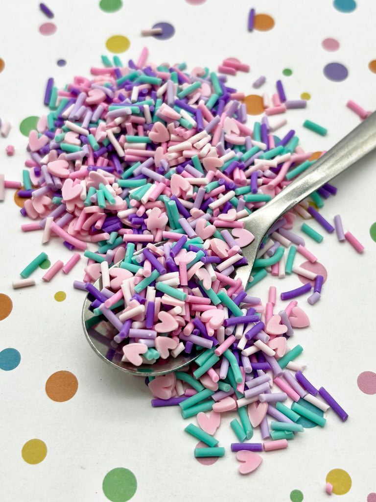 a spoon filled with sprinkles on top of a table