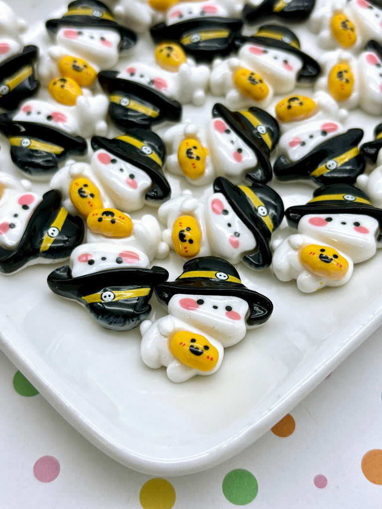 a white plate topped with lots of black and yellow candies