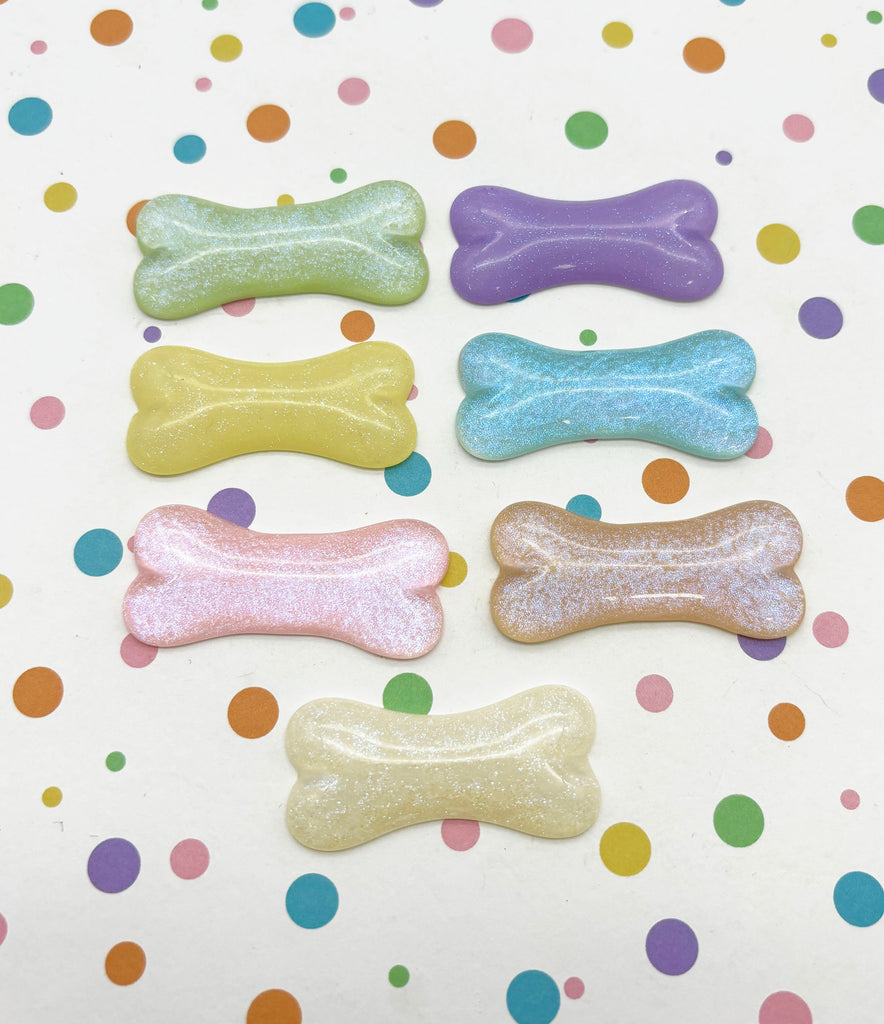 a group of dog bone magnets sitting on top of a table