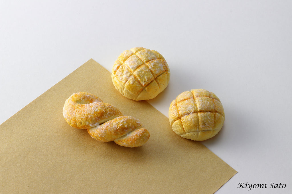 three pastries sitting on top of a piece of paper