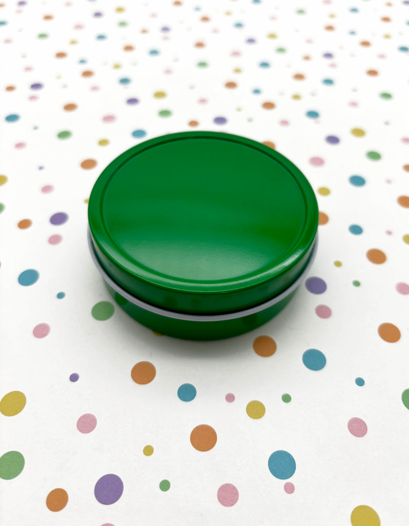 a green lid sitting on top of a polka dot table cloth