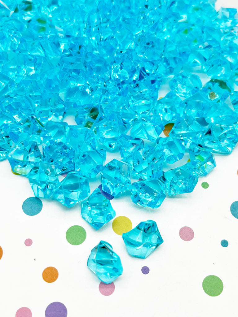 a pile of blue beads sitting on top of a table