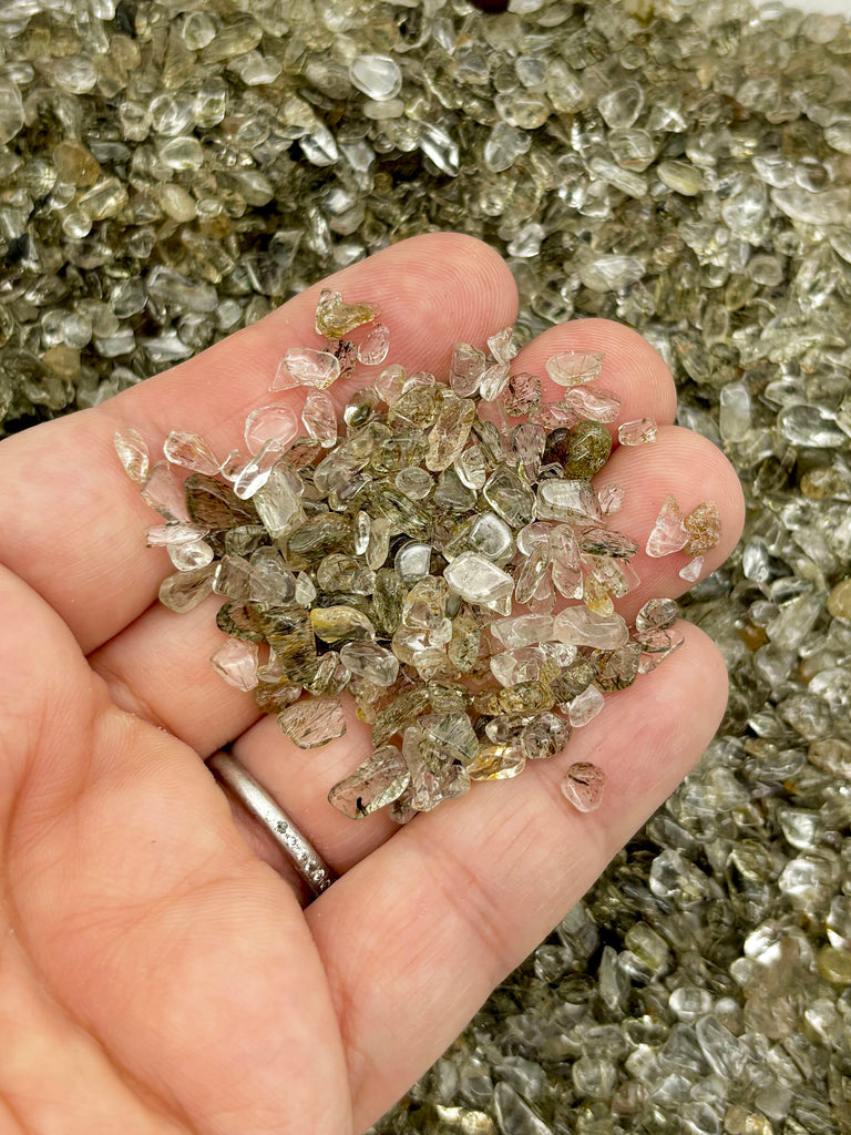 a person holding a handful of crystals in their hand