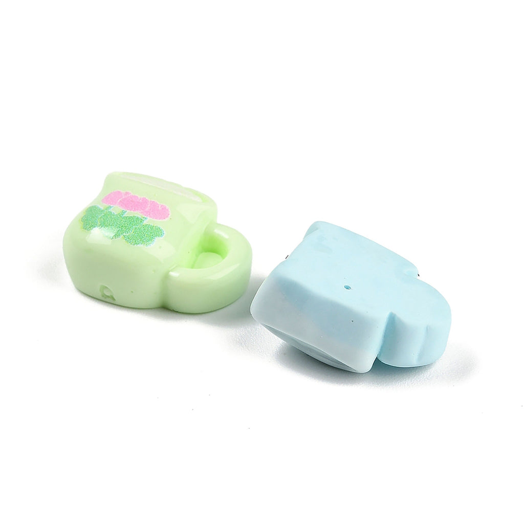 two small, colorful objects placed next to each other on a white background.