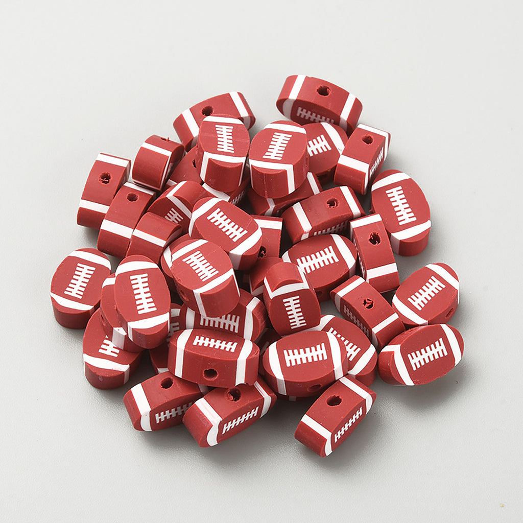 A pile of red and white football-shaped beads or charms.
