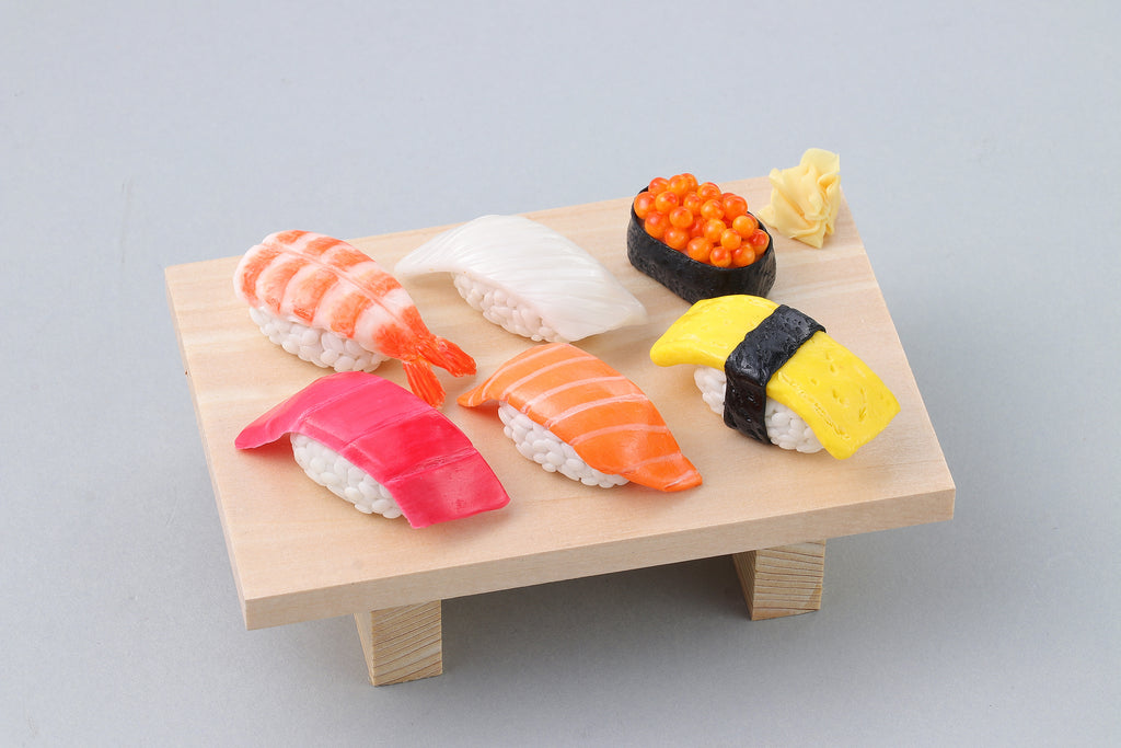 a wooden table topped with different types of sushi