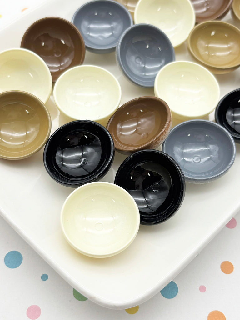 A white plate with a variety of colorful bowls and cups arranged on it.