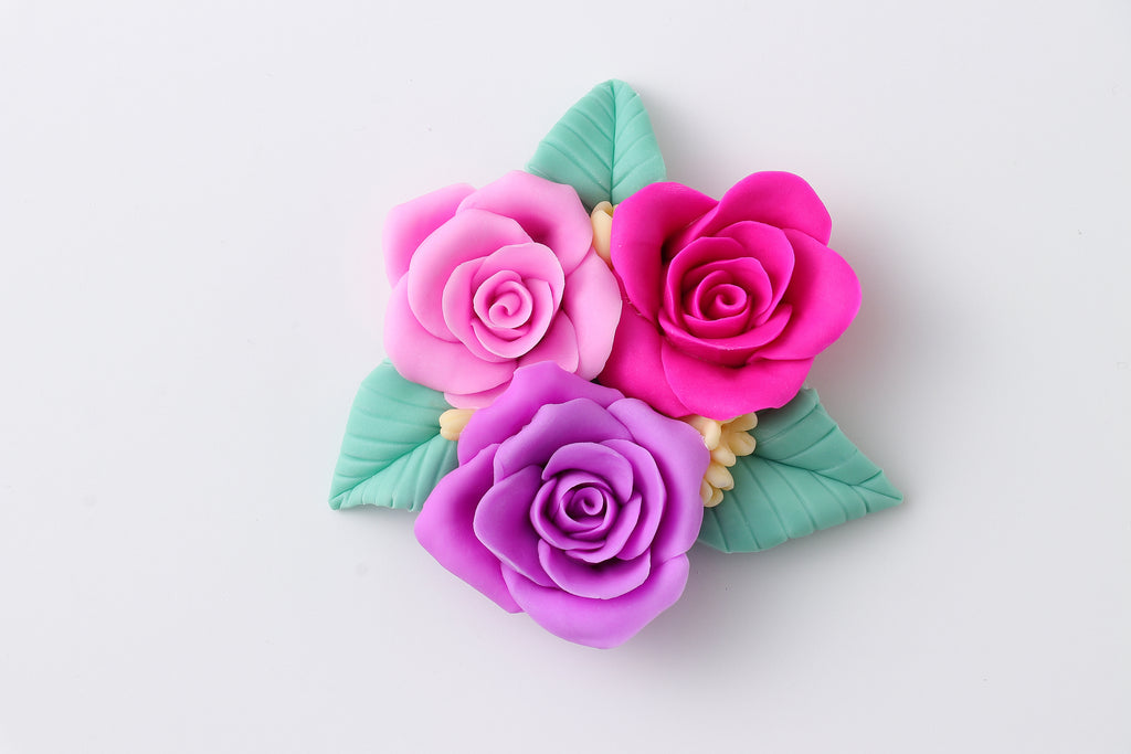 a bunch of pink and purple flowers on a white surface