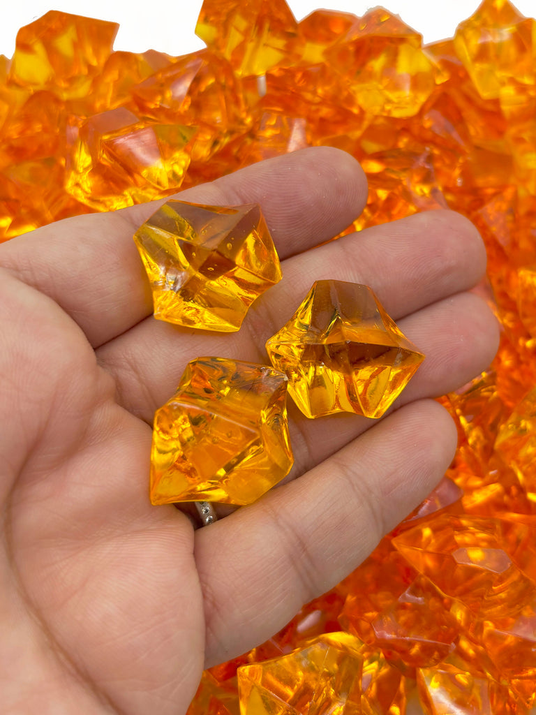 a hand holding a bunch of yellow crystals