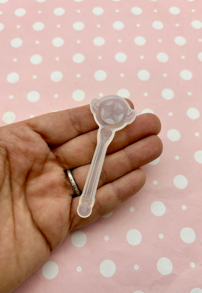 a person holding a plastic spoon in their hand