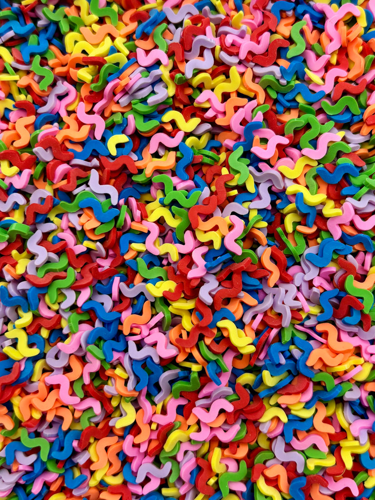 a large pile of multicolored plastic letters