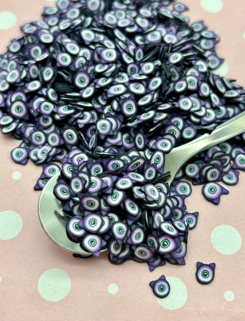 a spoon filled with purple and black beads