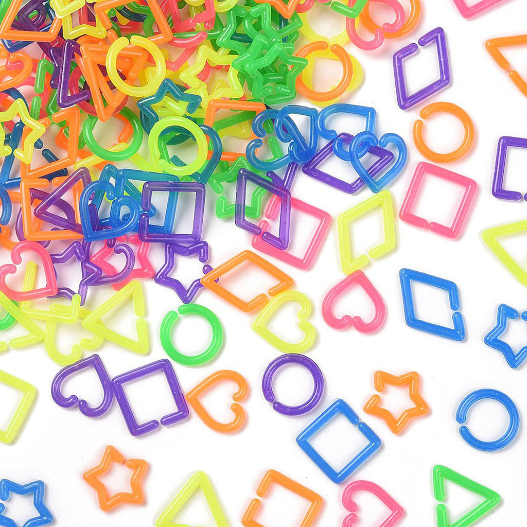 a variety of colorful plastic shapes, including stars, hearts, and other geometric designs, scattered across a white background.