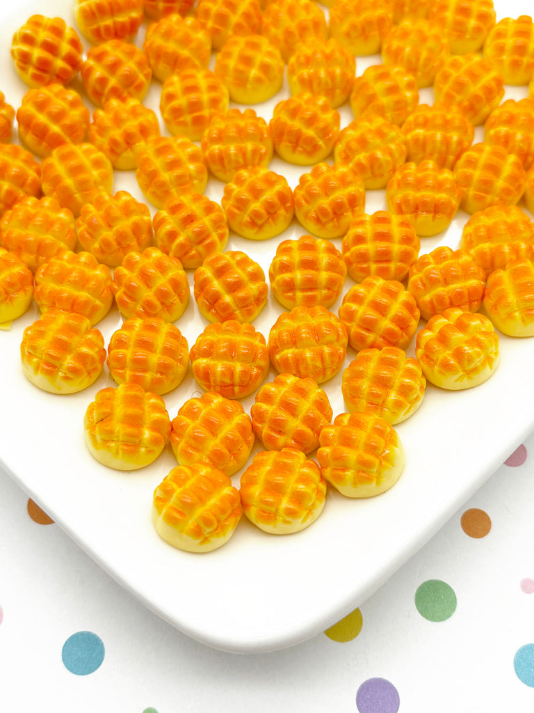 a white plate topped with yellow waffles on top of a polka dot table