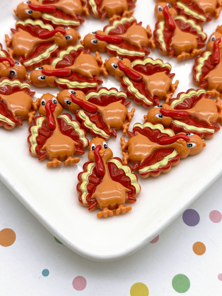 a white plate topped with cookies covered in frosting