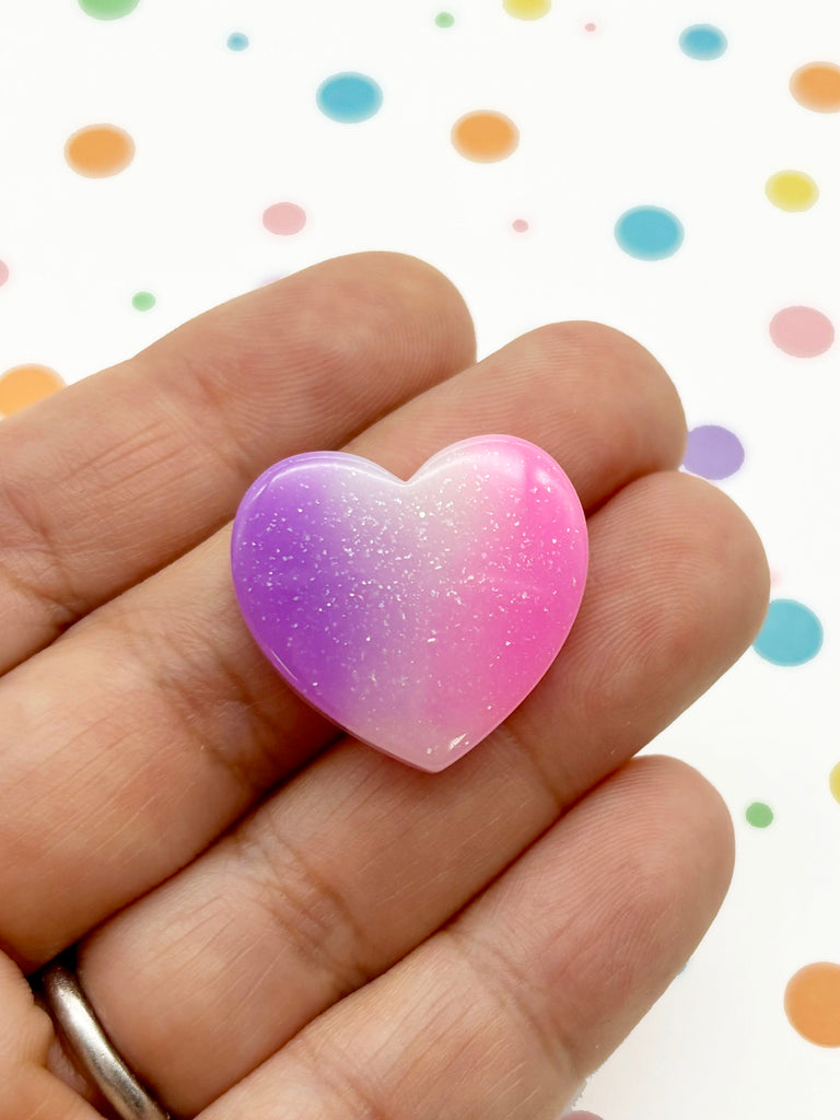 a person holding a heart shaped object in their hand