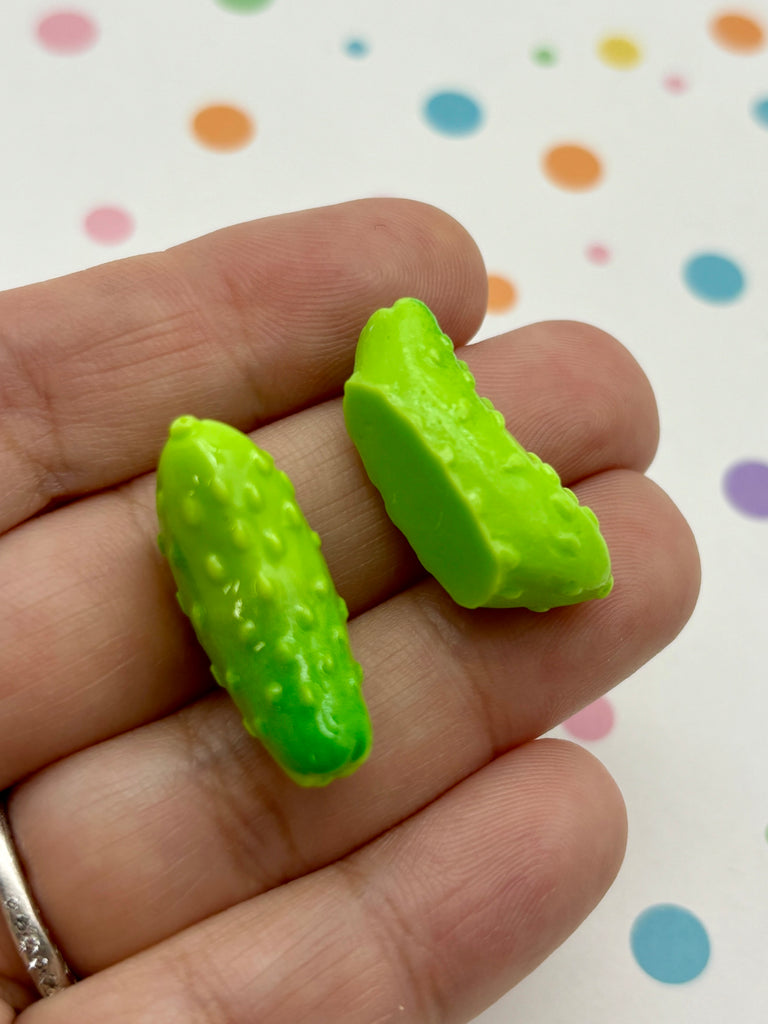 a person holding a tiny green object in their hand