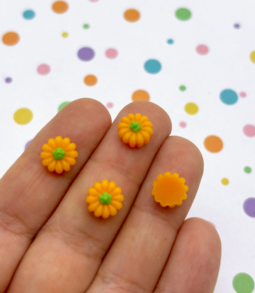 a person's hand holding a tiny yellow flower