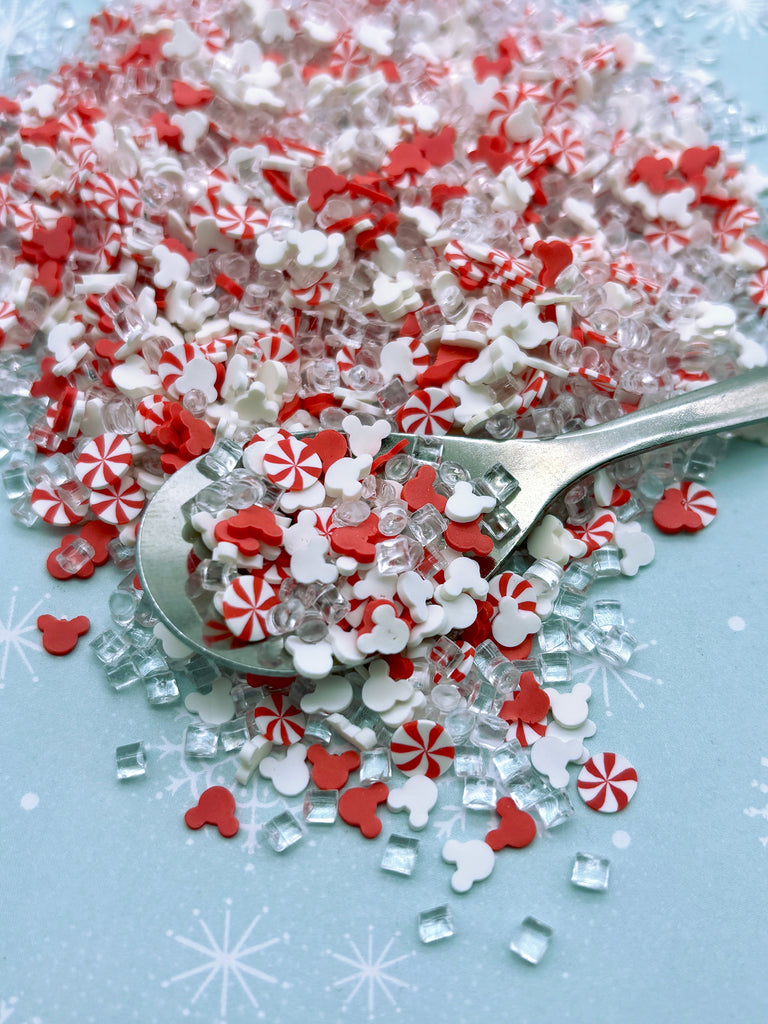 a spoon full of red and white sprinkles