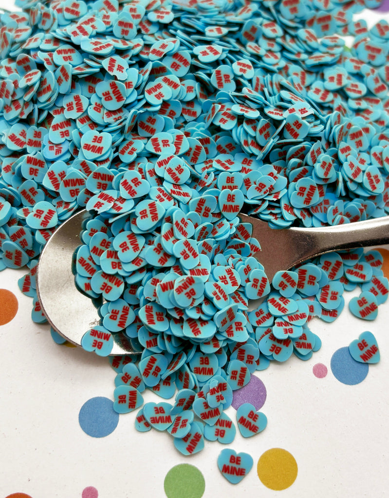 a spoon full of blue and red confetti