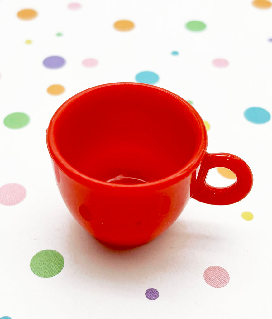 a red cup sitting on top of a table