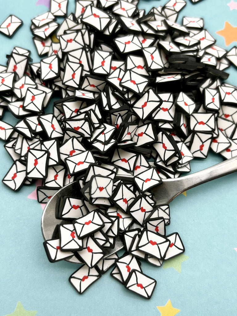 a spoon full of black and white origami pieces