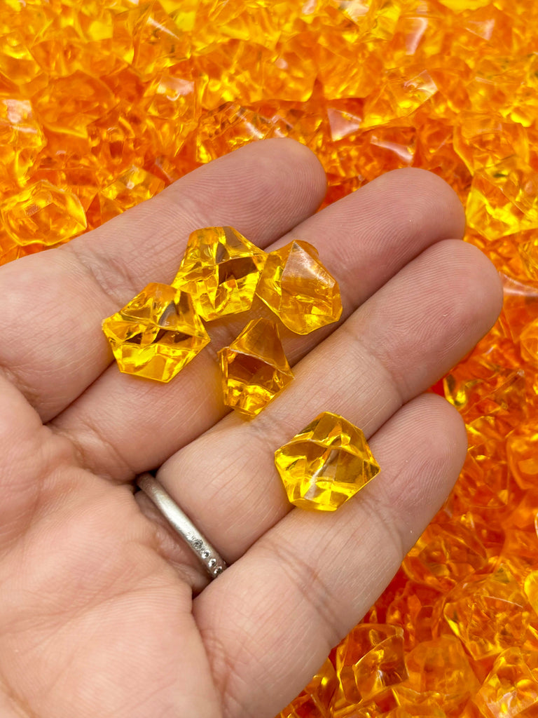 a hand holding a bunch of yellow crystals