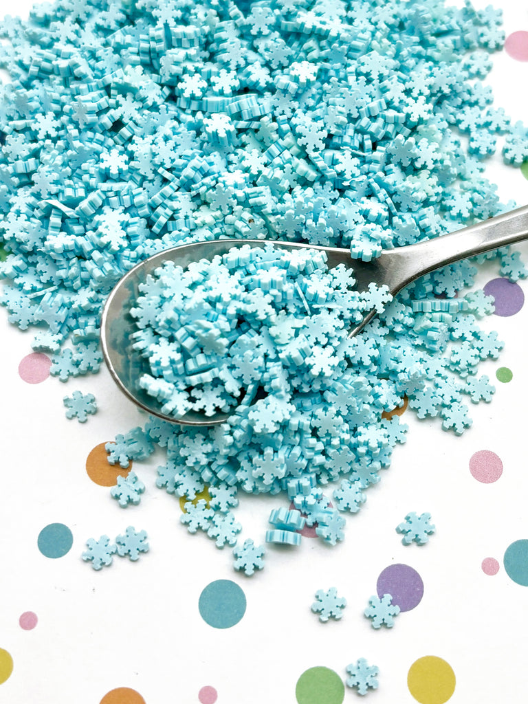 a pile of blue sprinkles sitting on top of a table