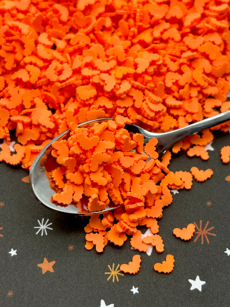 a spoon full of orange sugar flakes on a table