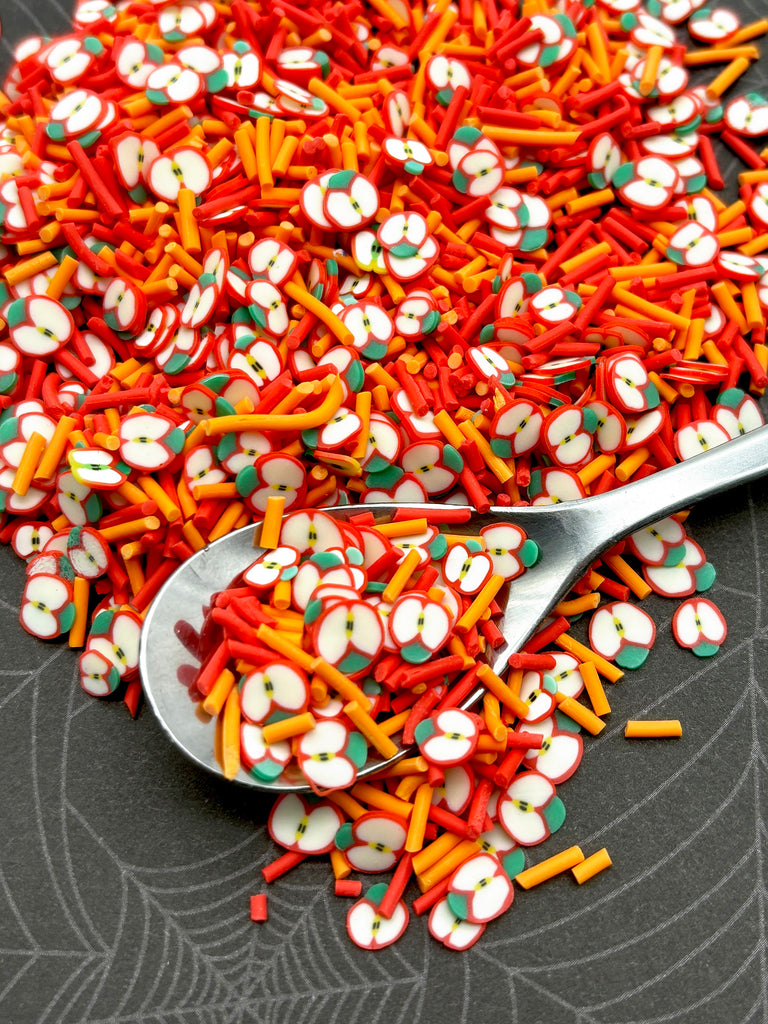 a spoon full of candy sprinkles on a table