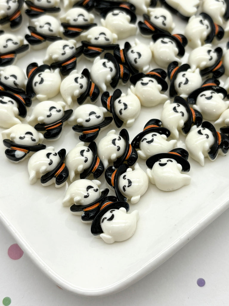 a white plate topped with lots of black and white marshmallows