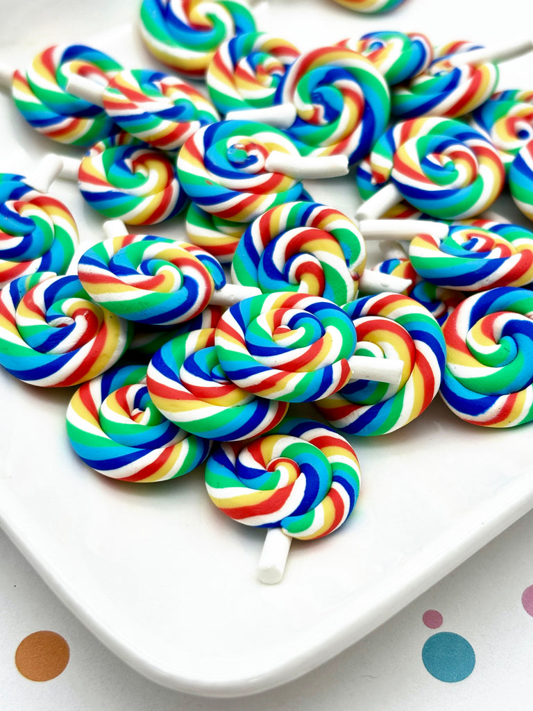 a white plate topped with lollipops on top of a table