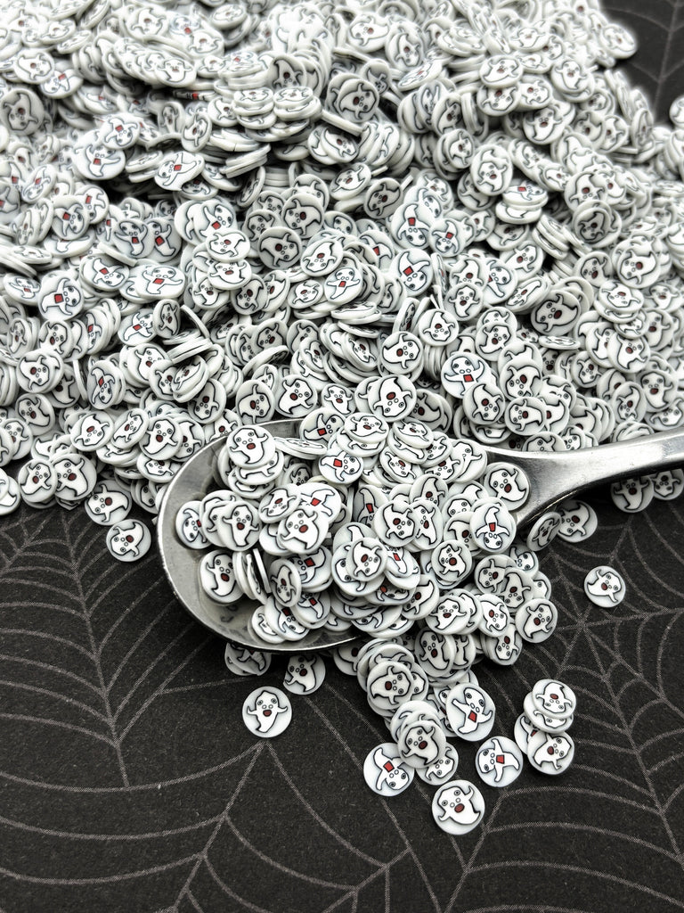 a pile of silver buttons sitting on top of a table