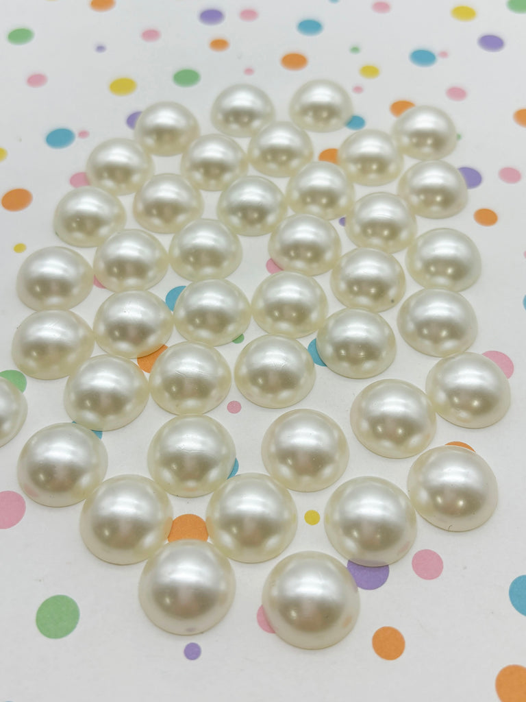 a bunch of white pearls sitting on top of a table