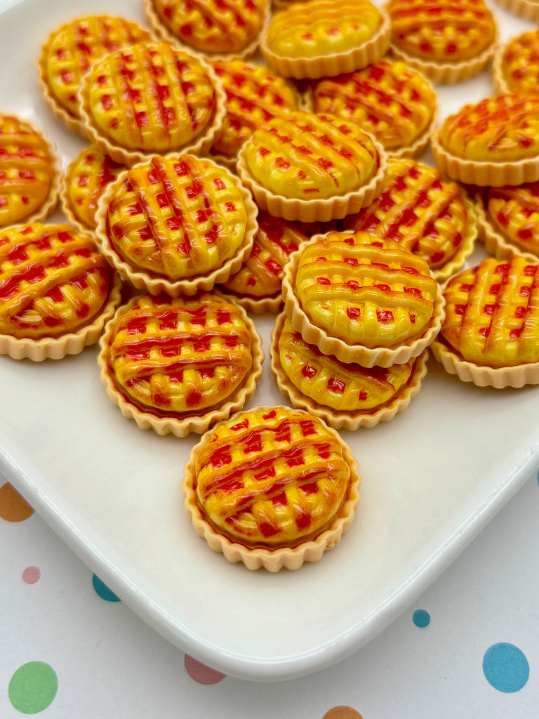 a white plate topped with mini pies on top of a table