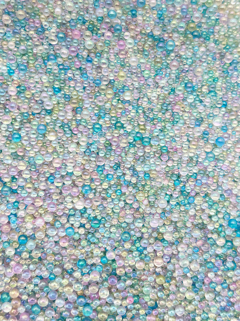 The image is a collage of various multicolored bubbles, creating a vibrant and visually striking pattern.