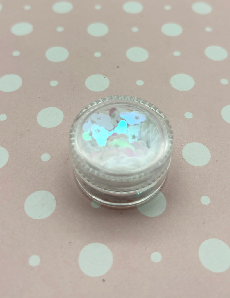 a small glass container with a white and blue design on it